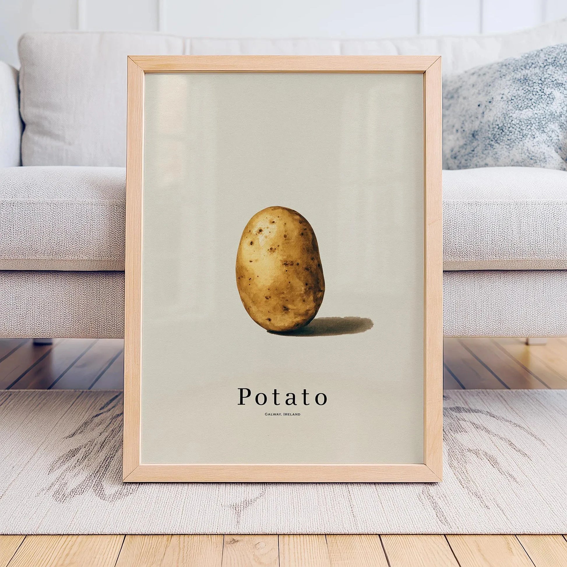 Framed print of a potato on a light background, displayed in a living room.