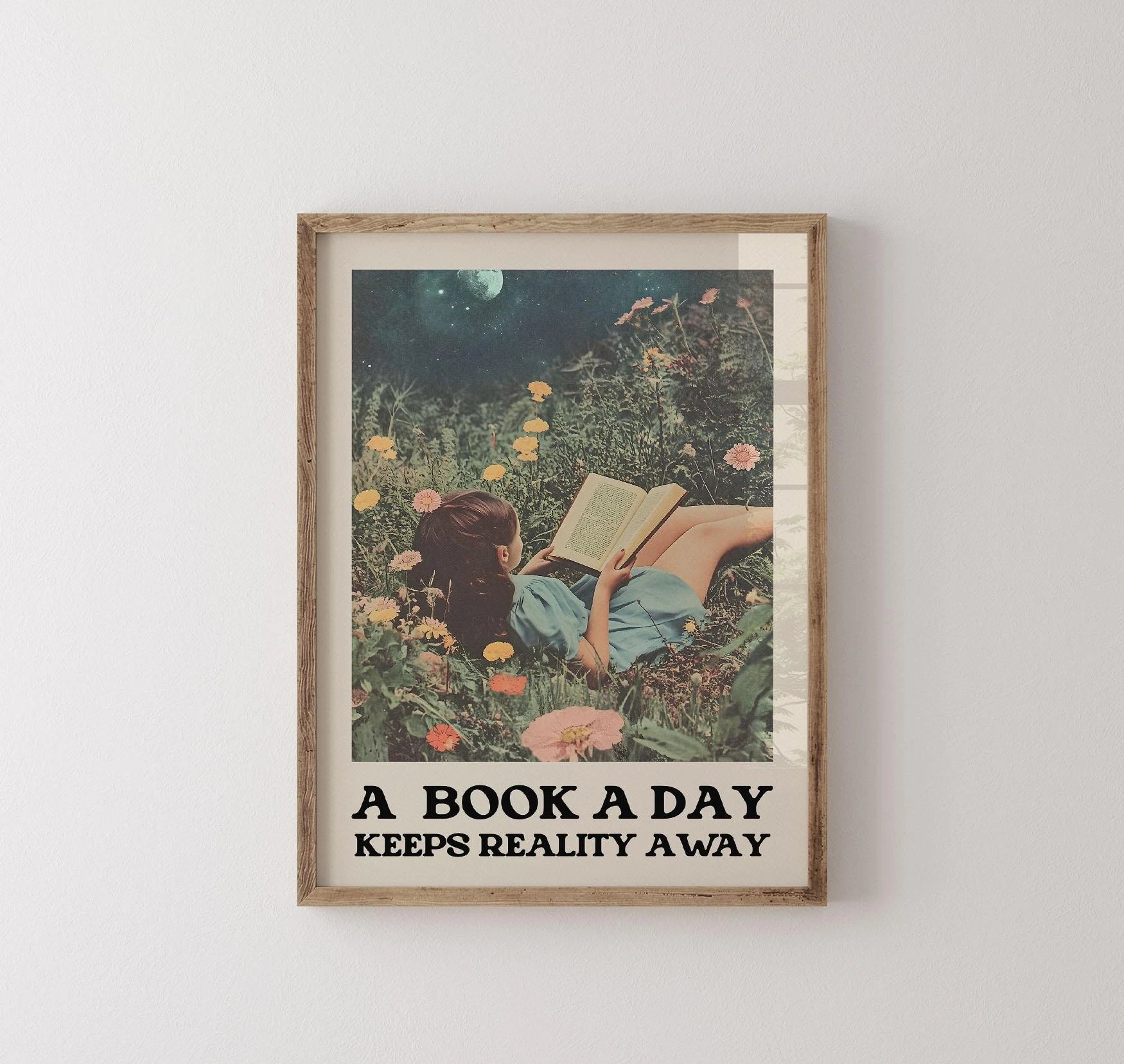 Framed artwork of a woman reading a book in a garden with text 'A Book A Day Keeps Reality Away' on a white wall.