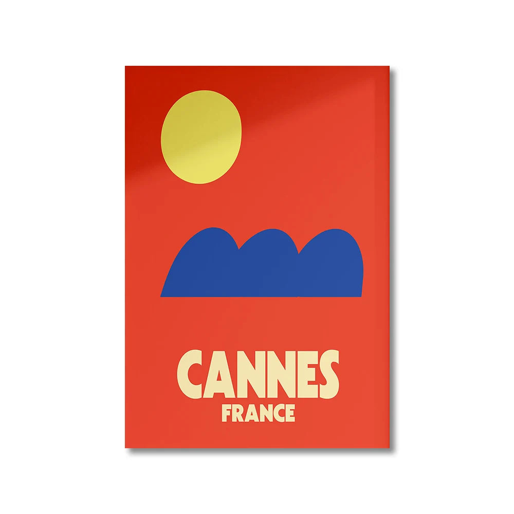 Poster with red background, yellow sun, blue mountains, and 'Cannes France' text.