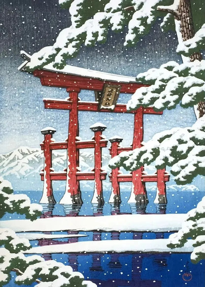 Red torii gate in a snowy landscape with mountains in the background