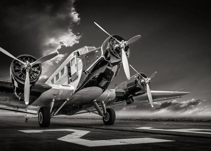 Vintage airplane on a runway with dramatic sky
