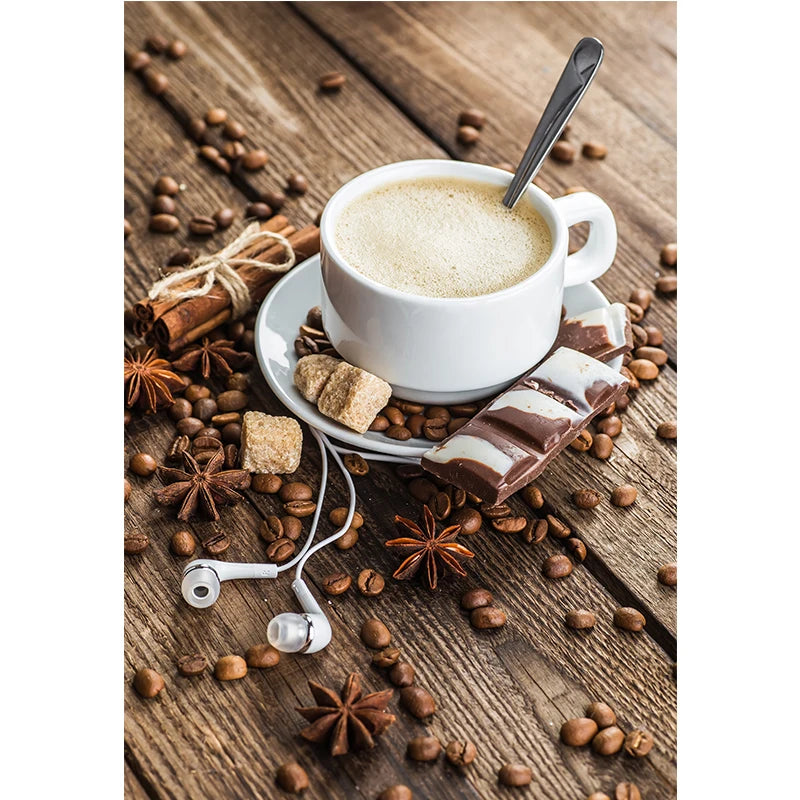 Cup of coffee with a spoon, cinnamon stick, and star anise on a wooden surface.