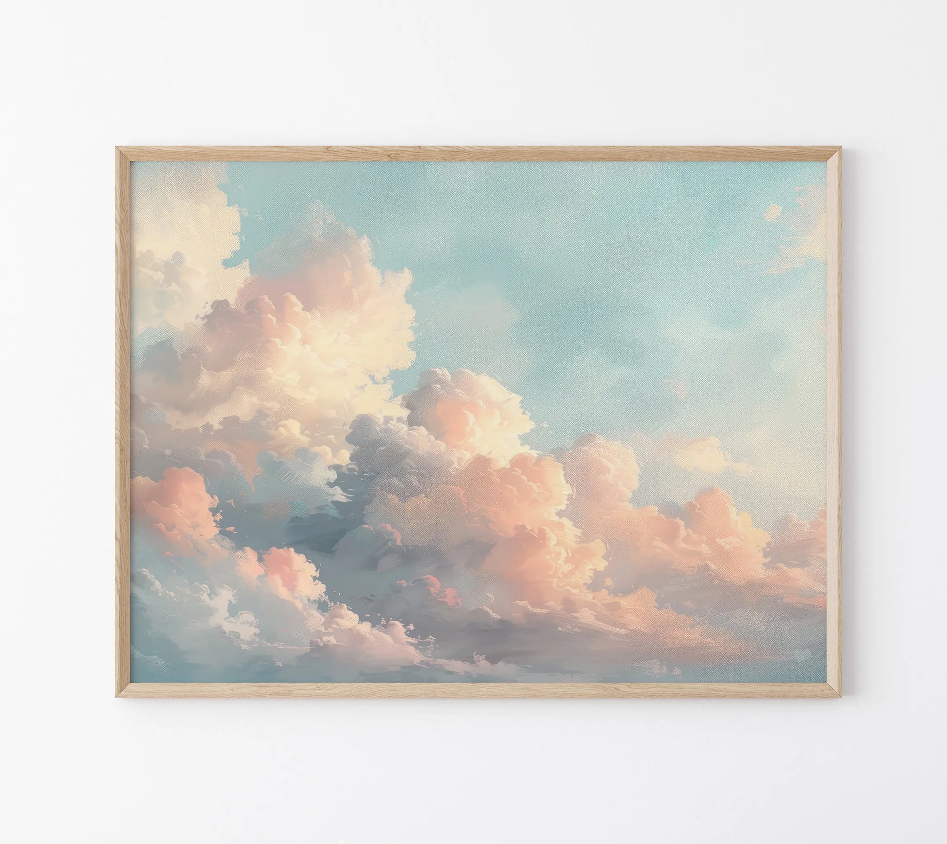 Framed artwork of a cloud scene with pastel colors on a white wall