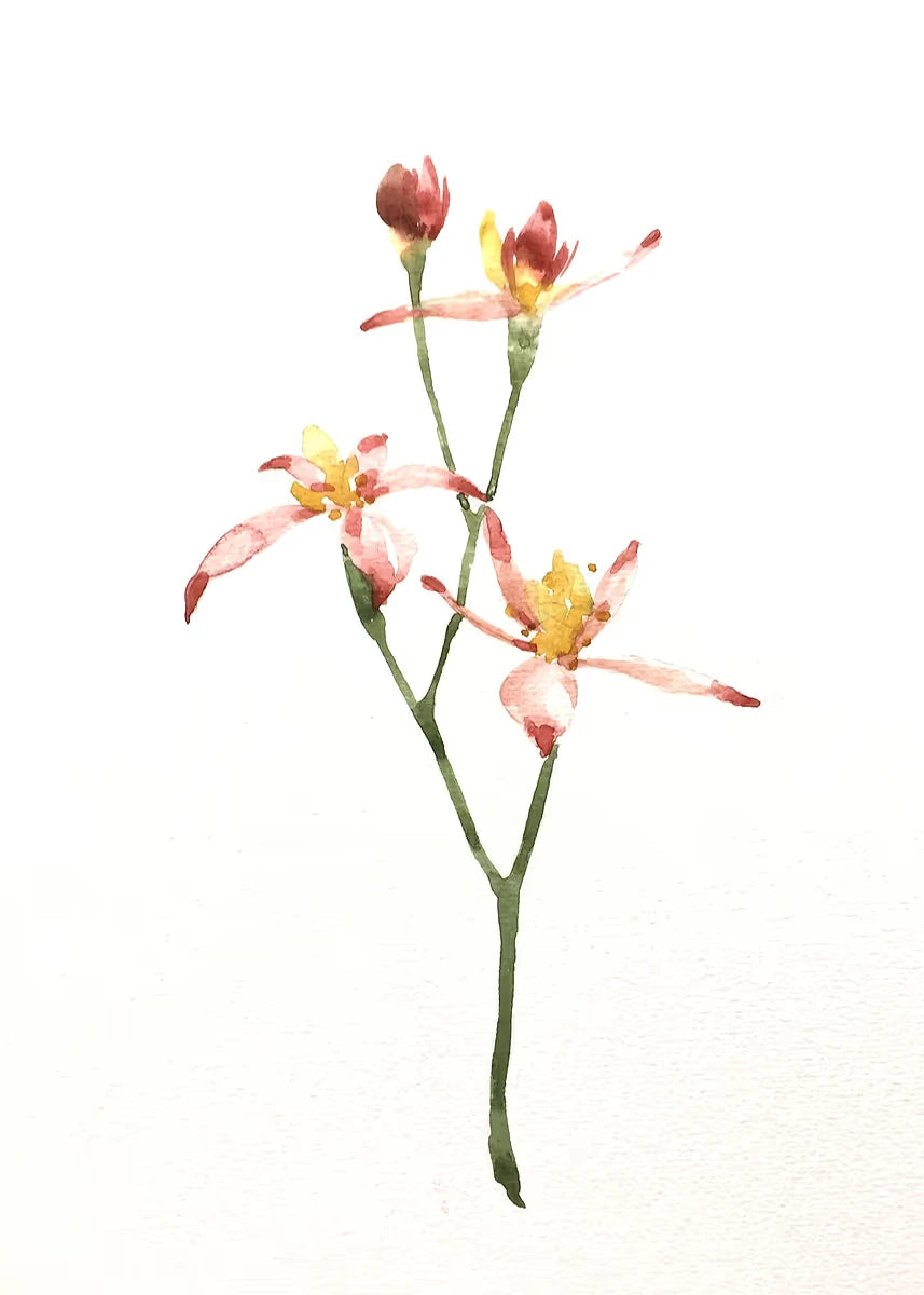 Artificial flower branch with pink and yellow flowers on a white background