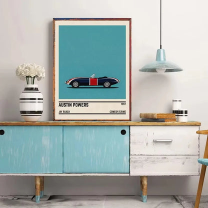 Framed poster of a vintage car on a wall above a wooden sideboard.