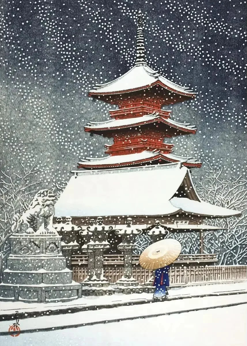 Traditional Japanese pagoda in the snow with a person holding an umbrella.