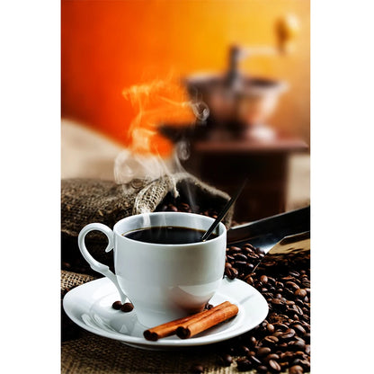 Steaming cup of coffee with a cinnamon stick on a saucer, surrounded by coffee beans.