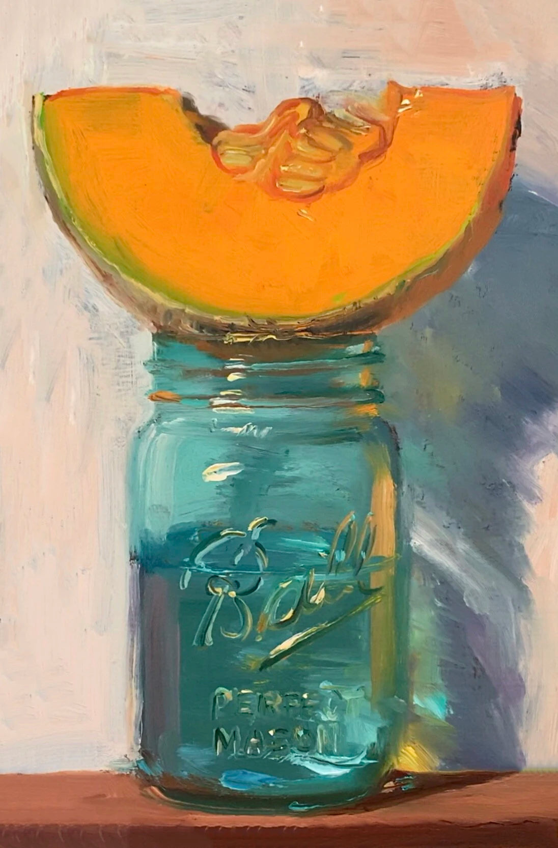 Sliced cantaloupe on a blue Ball jar against a textured background