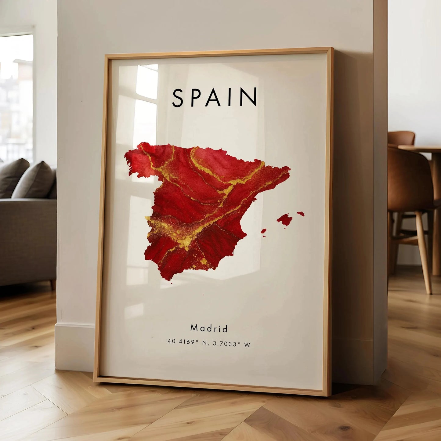 Framed map of Spain with Madrid coordinates on a wall in a room.