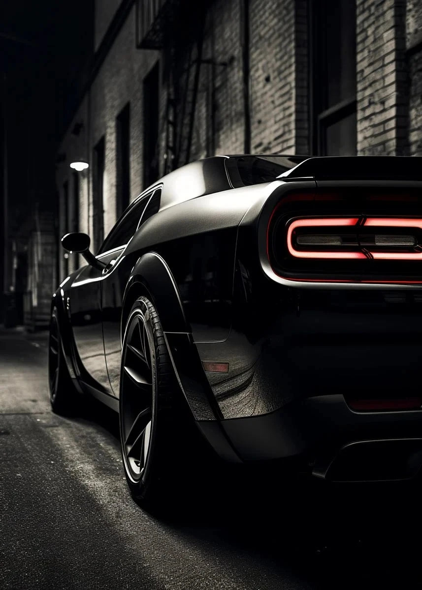 Black sports car with red accents parked on a street at night.