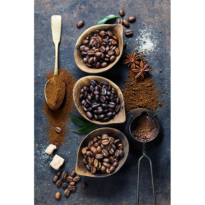 Coffee beans and coffee powder on a dark surface with a rustic feel.