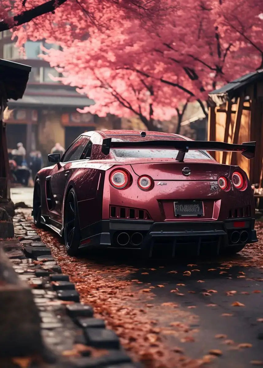 Red sports car parked on a street with cherry blossom trees in the background