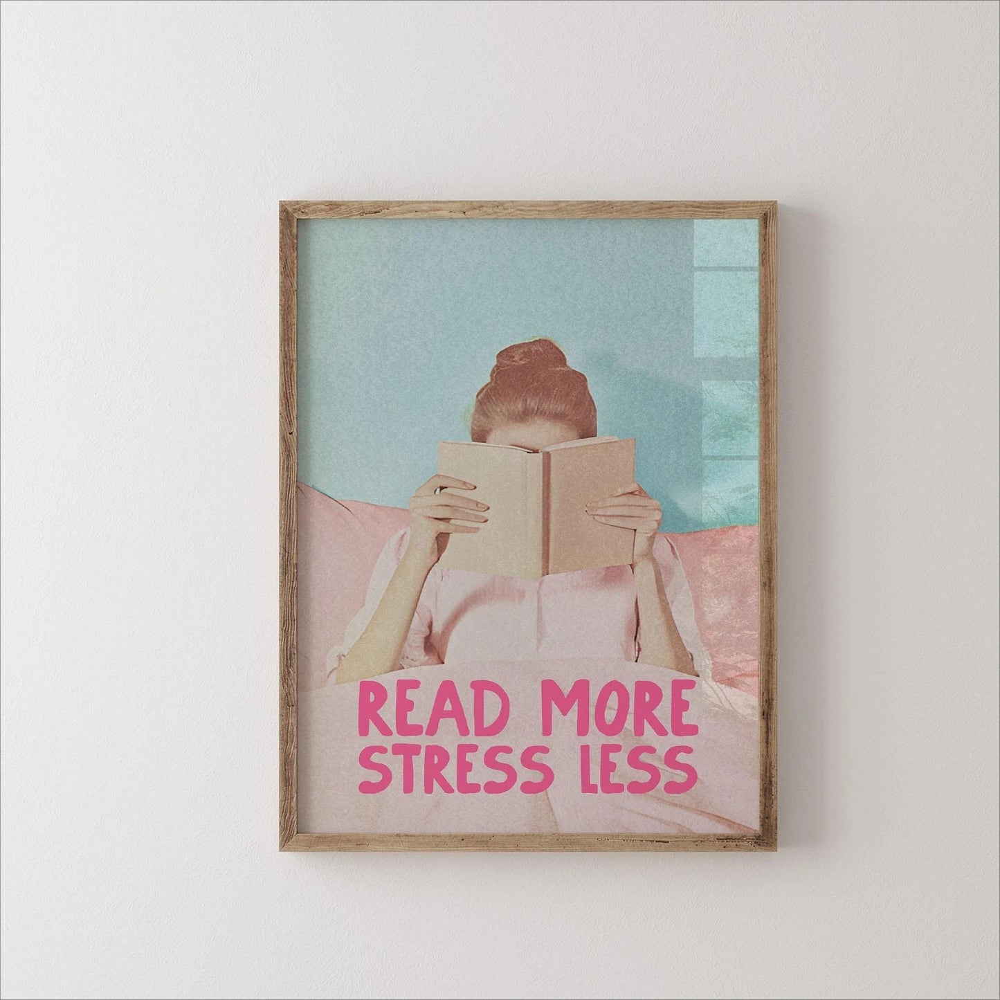 Framed artwork with a person reading a book and 'Read More Stress Less' text on a light background