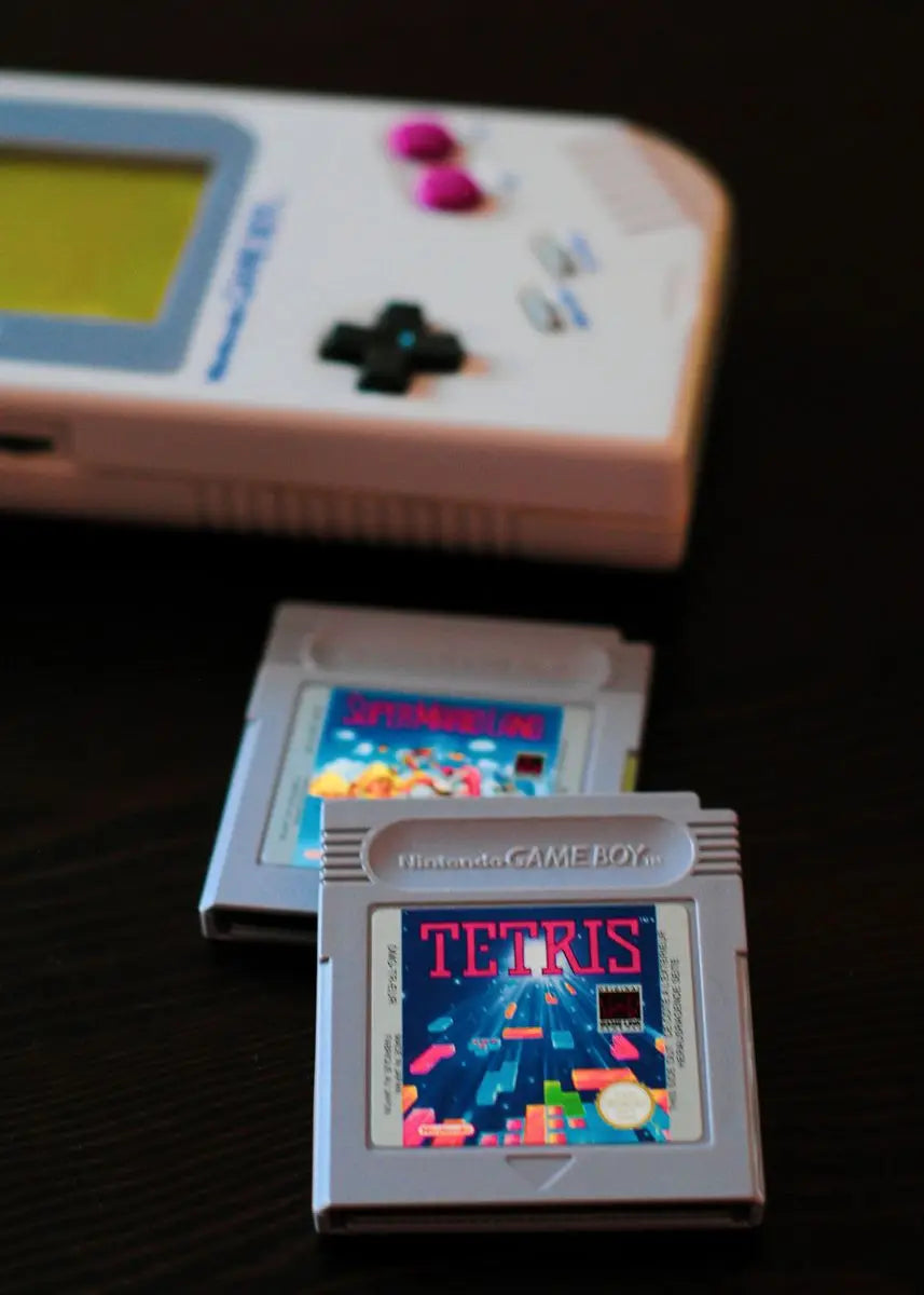 Vintage Game Boy with a 'Tetris' cartridge on a dark background