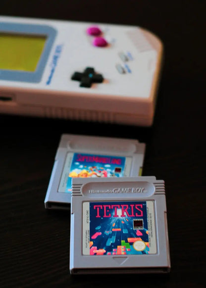 Vintage Game Boy with a 'Tetris' cartridge on a dark background
