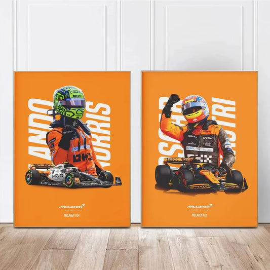 Two orange posters featuring racing drivers and cars on a wooden floor. Canvas & Curio