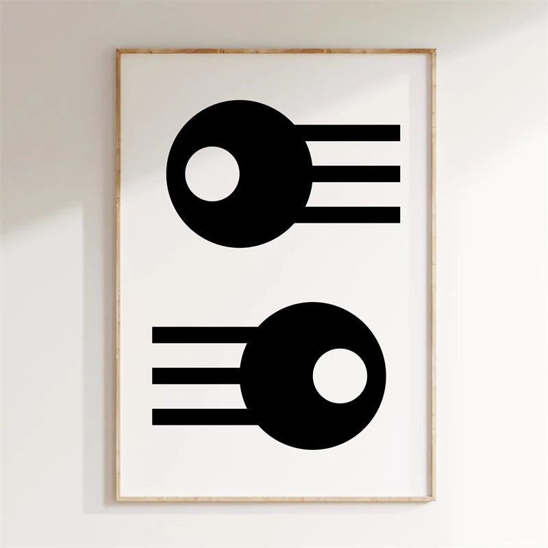 Framed abstract art print with black shapes on a white background