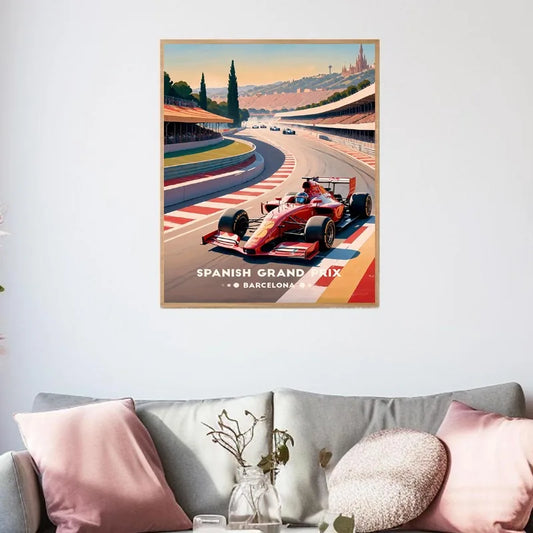 Poster of a race car on a track with 'Spanish Grand Prix' text, above a sofa with decorative pillows. Canvas & Curio
