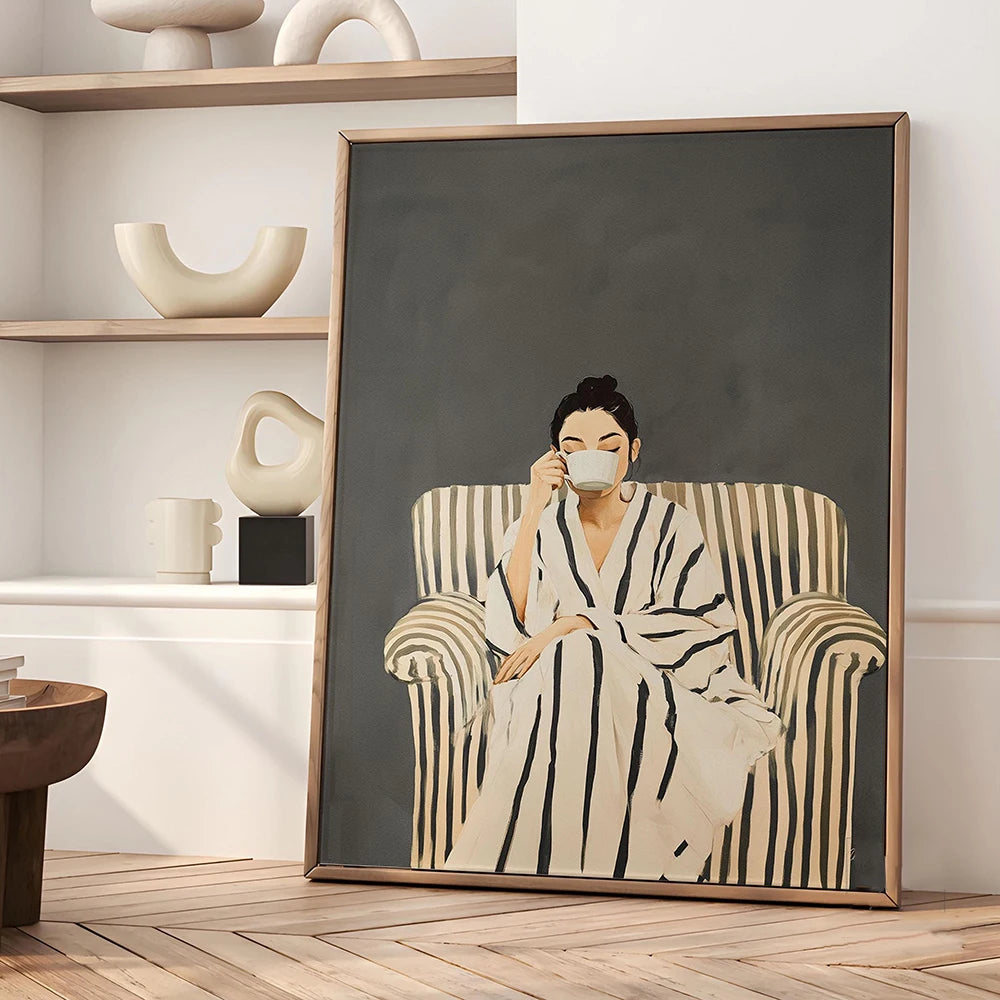 Framed artwork of a woman in a robe with a cat, displayed in a room with shelves and decor.