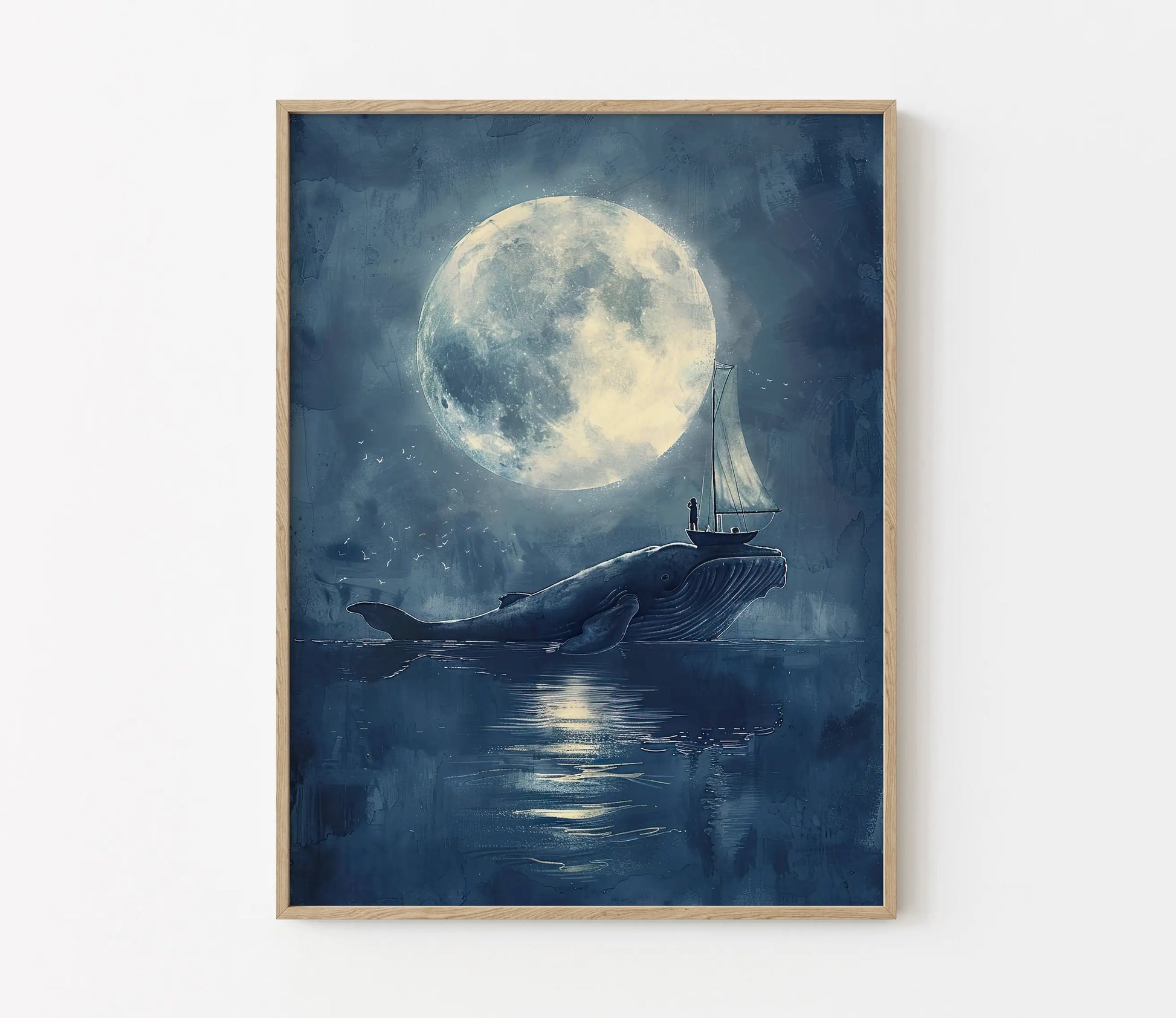 Framed artwork of a whale with a sailboat under a large moon on a blue background.