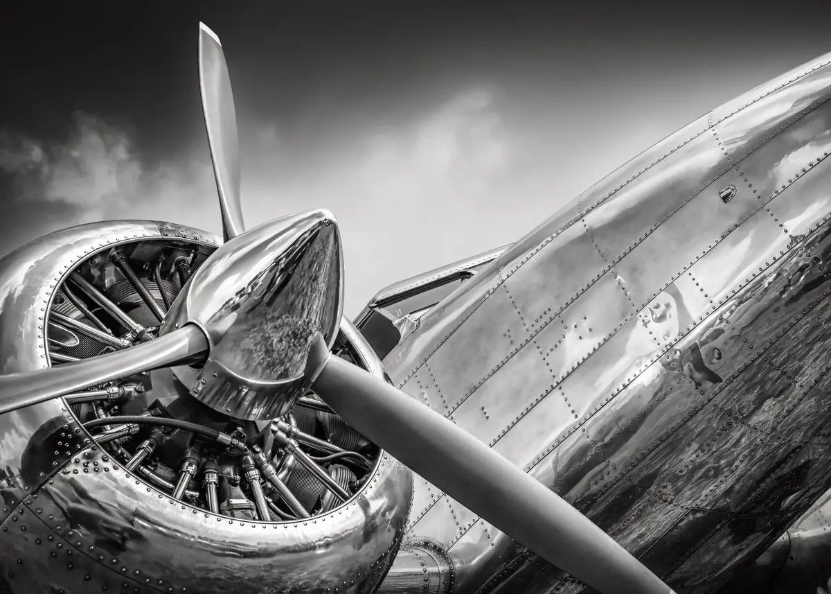 Close-up of a vintage airplane propeller against a cloudy sky.