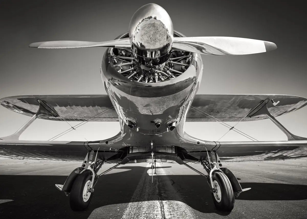 Black and white photo of a vintage airplane with a prominent propeller.