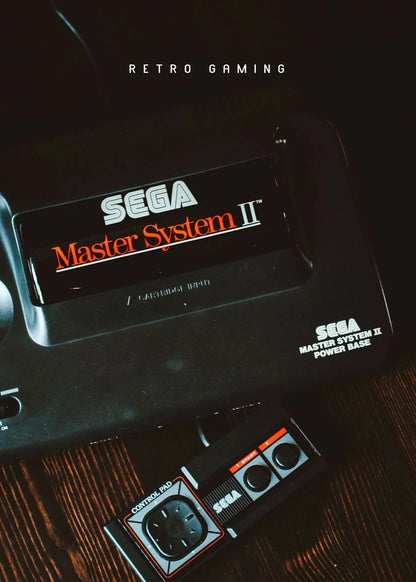Sega Master System II console and controller on a wooden surface with 'Retro Gaming' text above.
