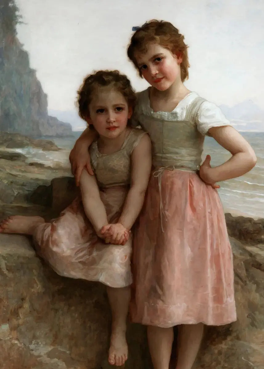 Two young girls in dresses sitting on a rocky beach with a scenic background.