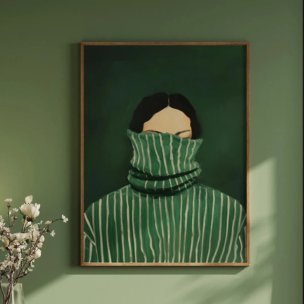 Framed artwork of a person wearing a green striped sweater against a green wall.