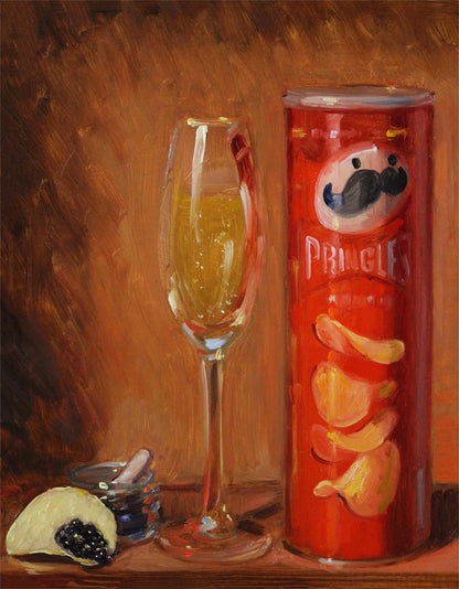 Pringles can with a glass of yellow liquid on a brown background
