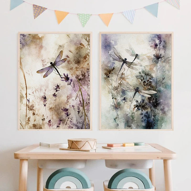 Two framed artworks of dragonflies on a wall above a wooden table with chairs.