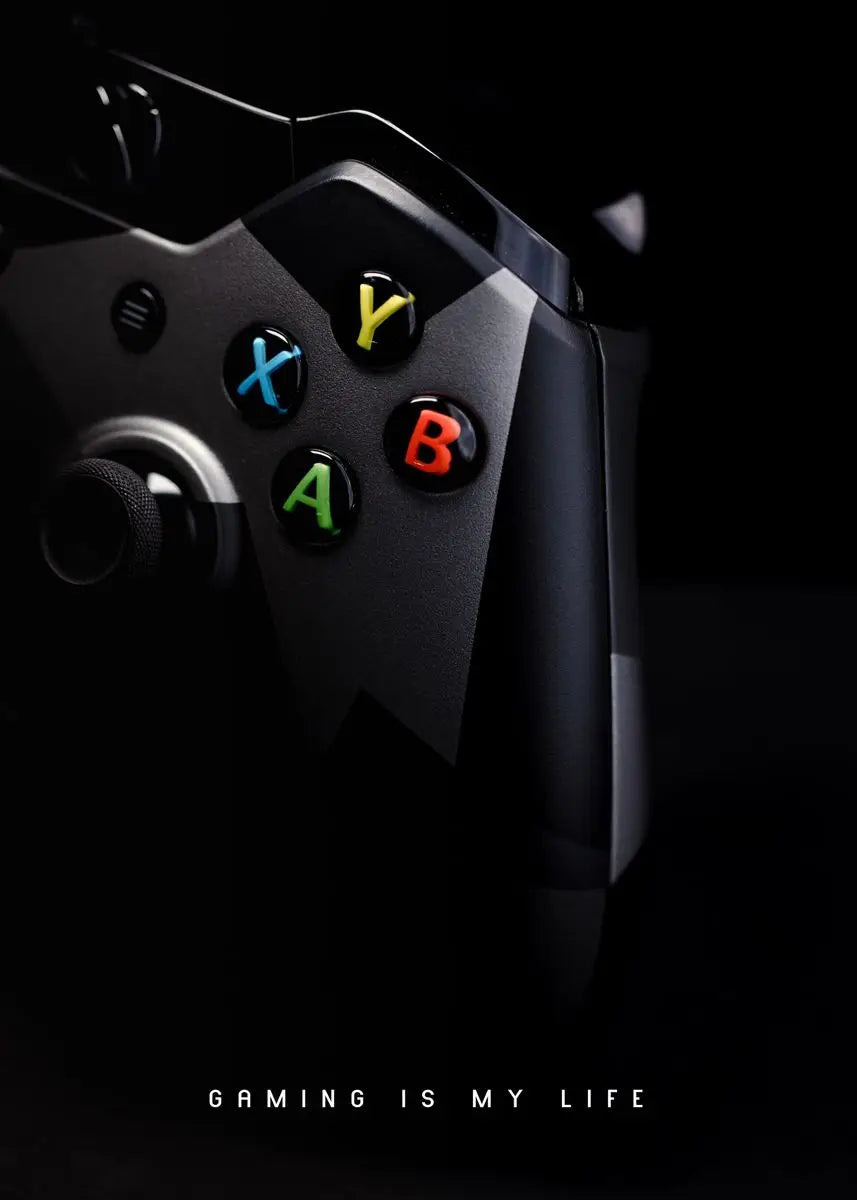 Close-up of a gaming controller with color-coded buttons on a black background, featuring the text 'Gaming is my life'.