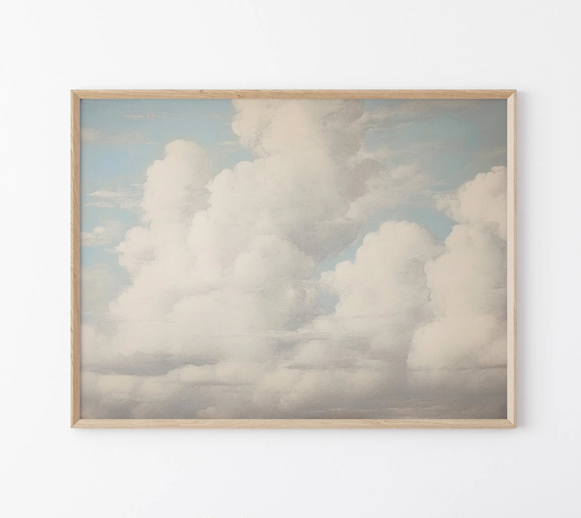 Framed artwork of fluffy clouds on a light blue background