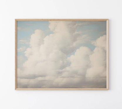 Framed artwork of fluffy clouds on a light blue background