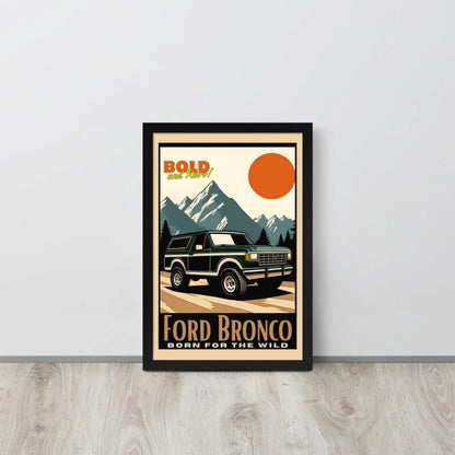 Framed poster of a Ford Bronco with mountain and sun design on a white wall.