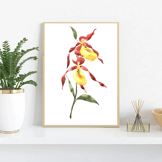 Framed artwork of red and yellow flowers on a white wall with a plant and decorative items below. Canvas & Curio