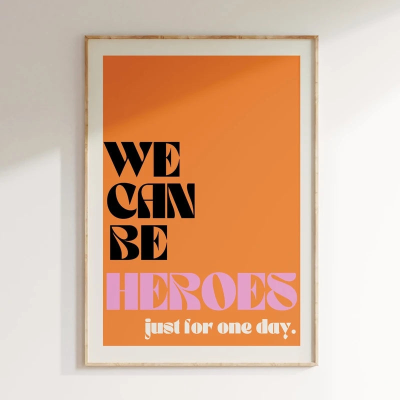 Framed poster with 'We can be heroes just for one day' text on an orange background