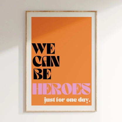 Framed poster with 'We can be heroes just for one day' text on an orange background