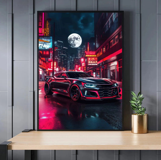 Framed poster of a black car on a city street at night with neon lights, mounted on a wall above a wooden surface. Canvas & Curio
