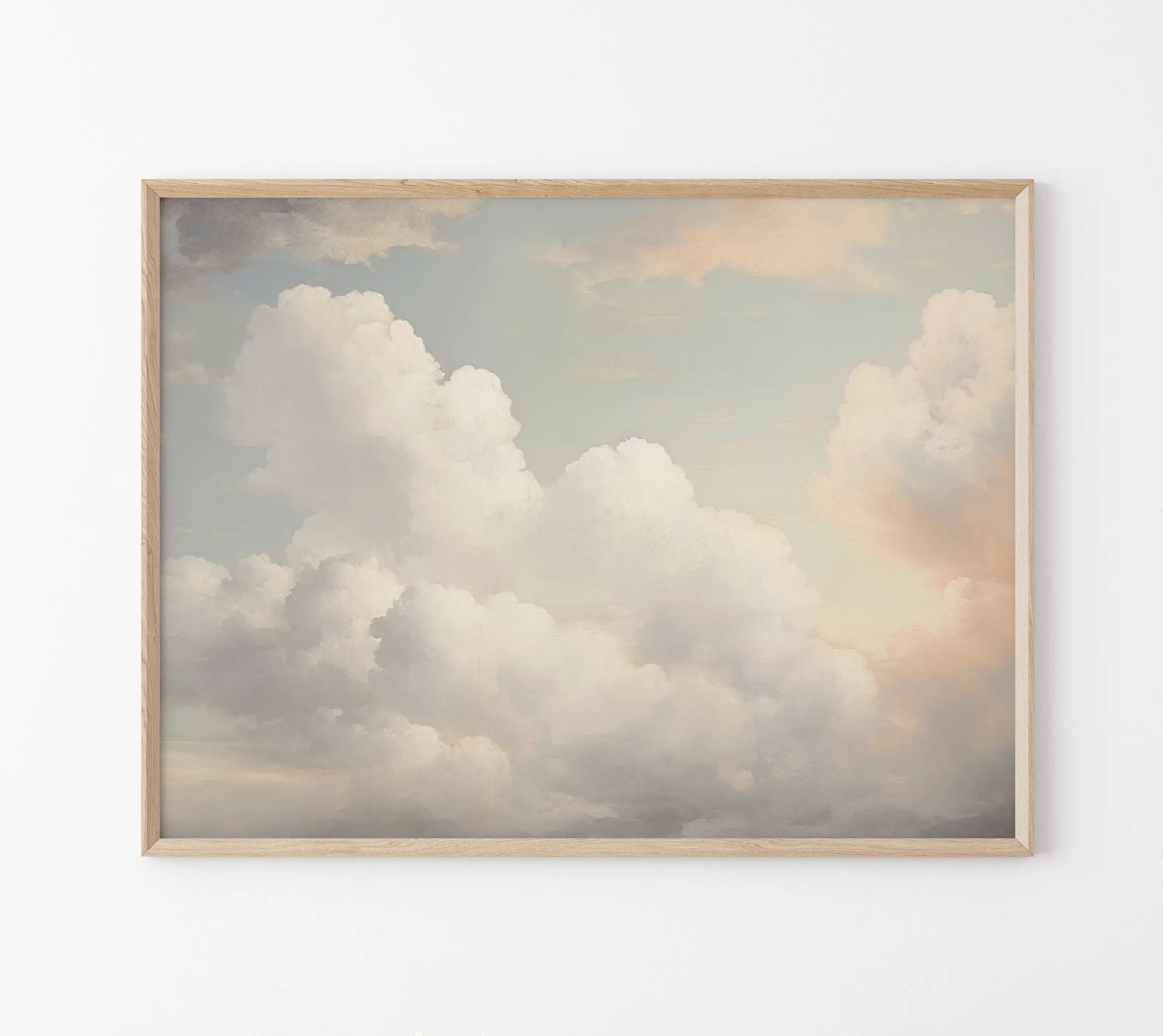 Framed artwork of fluffy clouds on a light background