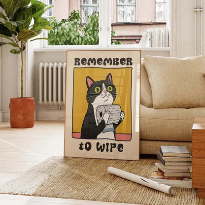 Poster with a cat illustration and text 'Remember to wipe' in a living room setting.