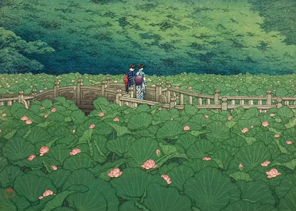 Two people walking on a bridge over a pond with lotus flowers, surrounded by greenery.