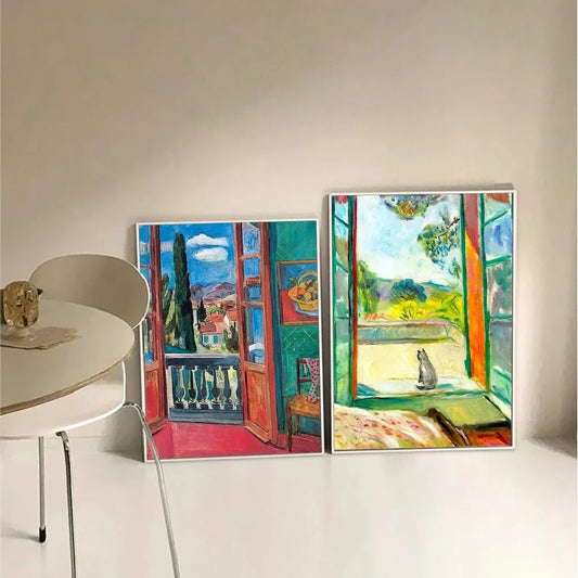 Two colorful artworks of open windows with views of landscapes on a white wall. Canvas & Curio