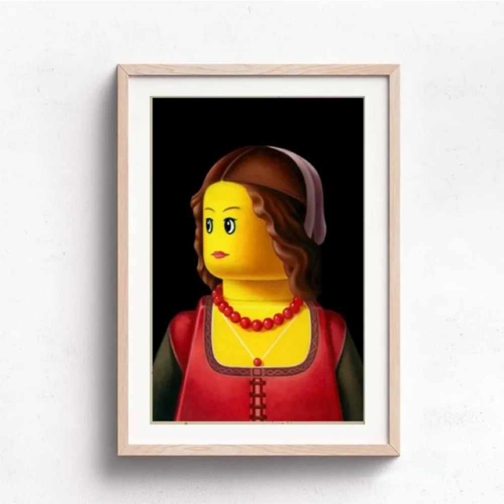 Framed artwork of a stylized portrait with a LEGO-like design on a white wall.