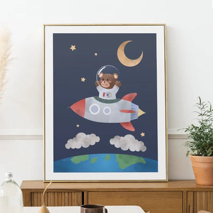Framed children's poster of a bear astronaut on a rocket with Earth and moon in the background.