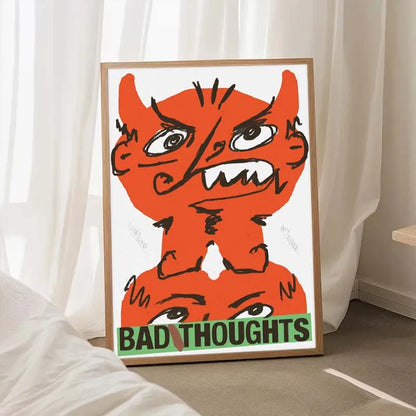 Framed artwork with an orange creature and 'Bad Thoughts' text on a white wall.