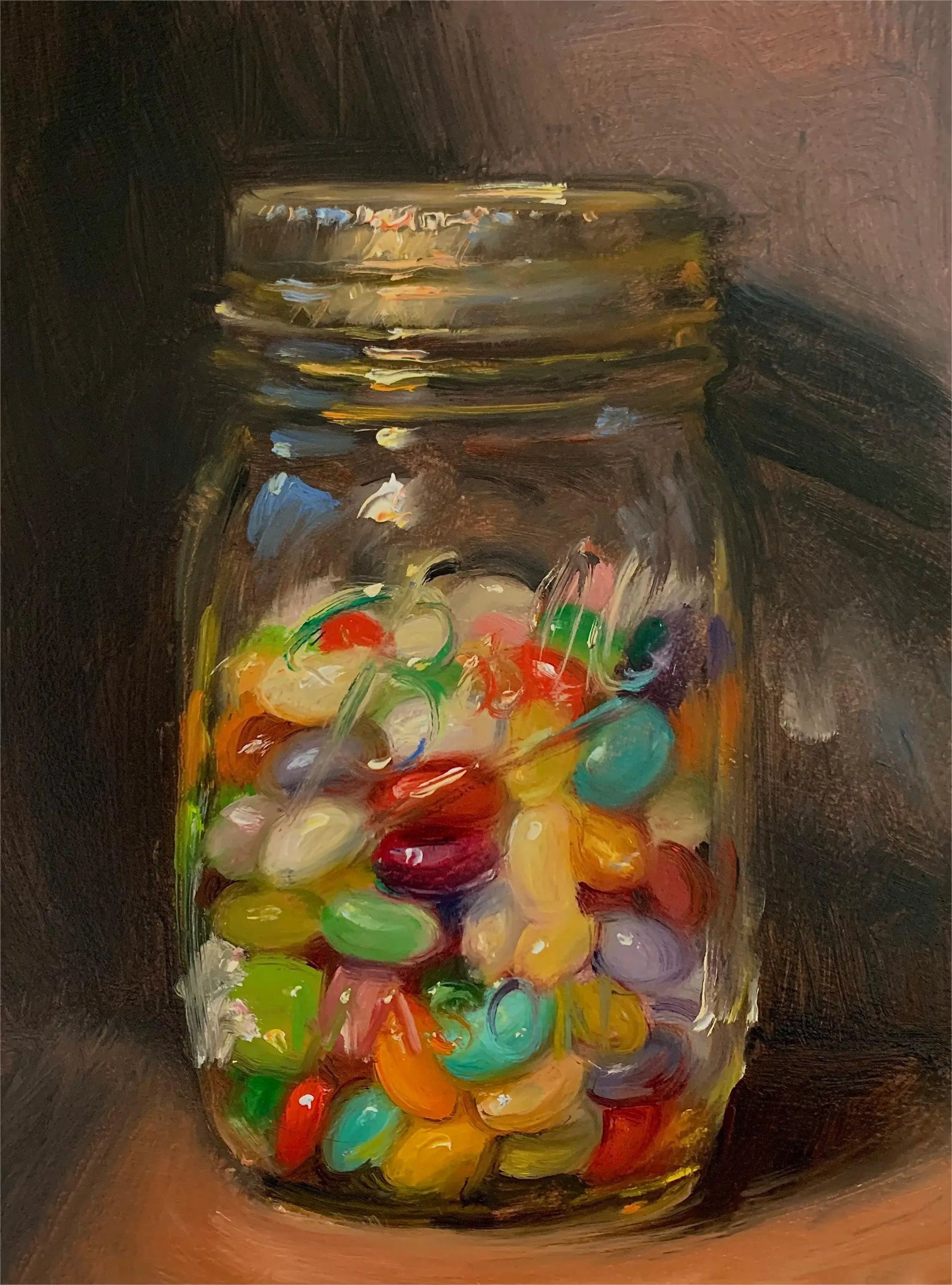 Glass jar filled with colorful jelly beans on a dark background