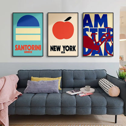 Gray sectional sofa with decorative pillows in a living room setting, featuring three colorful wall posters.