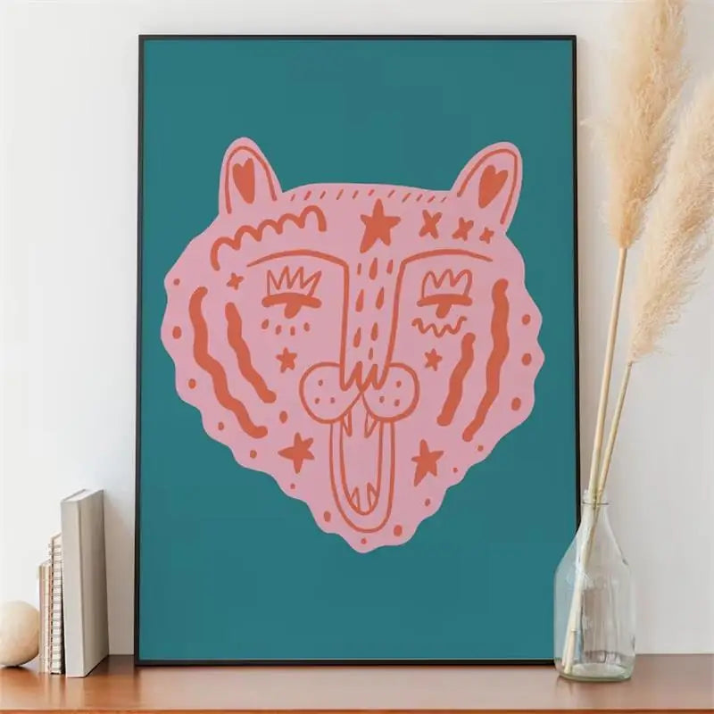 Framed pink fox illustration on a teal background, placed on a wooden surface with decorative items.