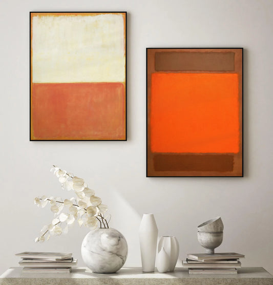 Two abstract paintings on a wall with decorative items on a table below. Canvas & Curio